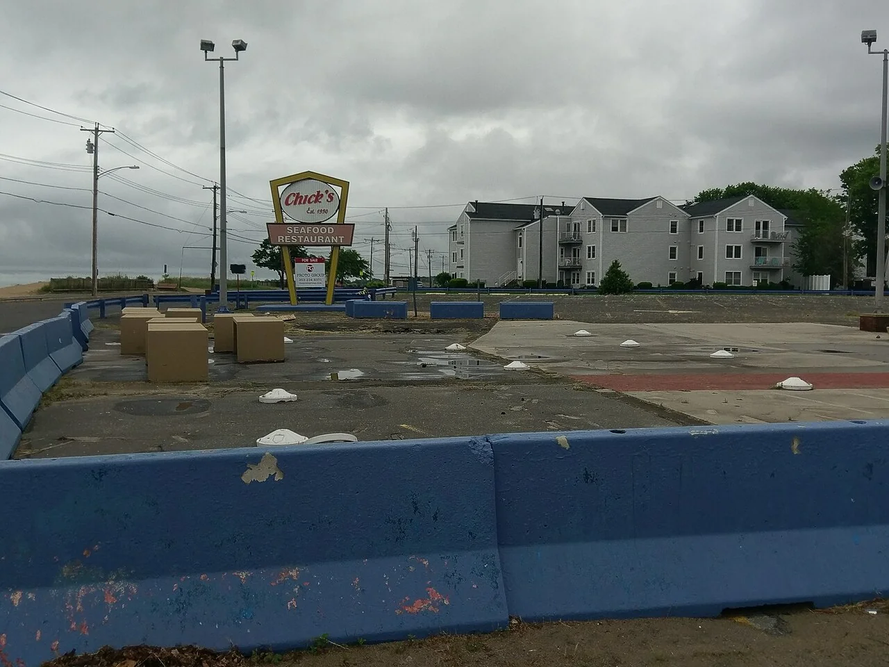 Roadside sign and empty parking area, 2017