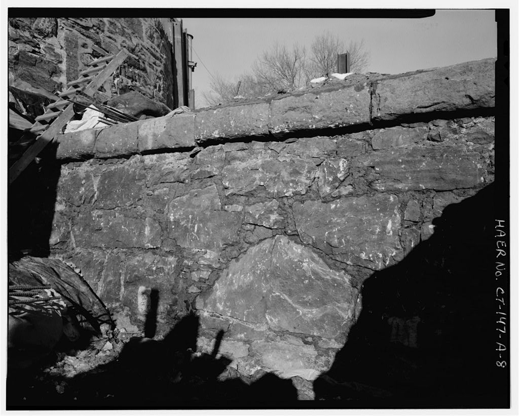 View north during construction, December 1995, face of original 1882 masonry dam with capstones
