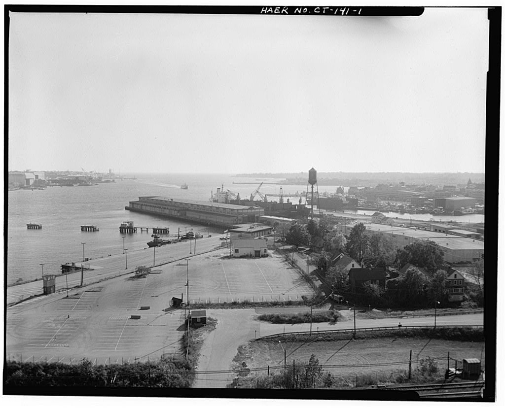 View southwest, general view from land, with ship Odigitria B docked along west side