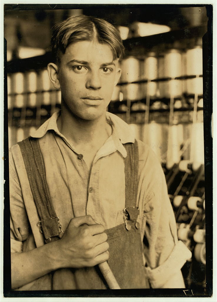 Young worker with spools in the background