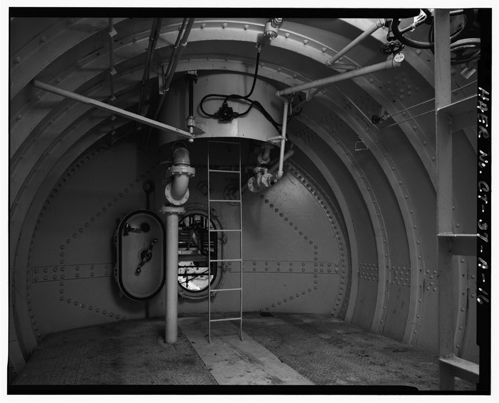 Interior view of submarine section at 110-foot level, escape training tank, showing ladder to escape tank, looking south